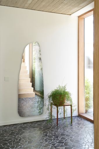 Rocca irregular wall mirror styled in an interior, highlighting irregular standing-stone-shaped mirror.