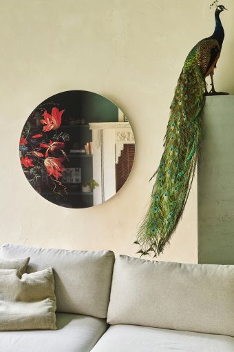 Museo round wall mirror styled in an interior, highlighting printed art mirror, measuring 100 x 100 cm.