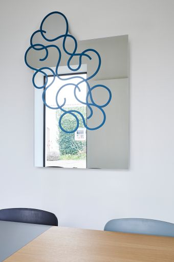 Twirl Blue irregular wall mirror styled in an interior, highlighting irregular wall mirror.