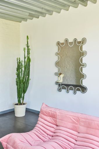 Wiggle irregular wall mirror styled in an interior, highlighting irregular wavy-edged mirror.