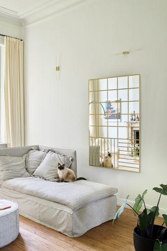 Grid Gold rectangular wall mirror styled in an interior, highlighting golden printed grid pattern.