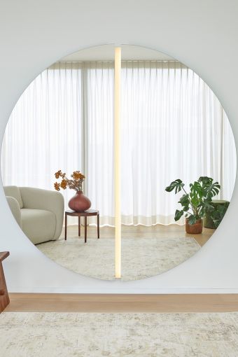 Luna Light Round L round wall mirror styled in an interior, highlighting large round mirror with integrated LED light.
